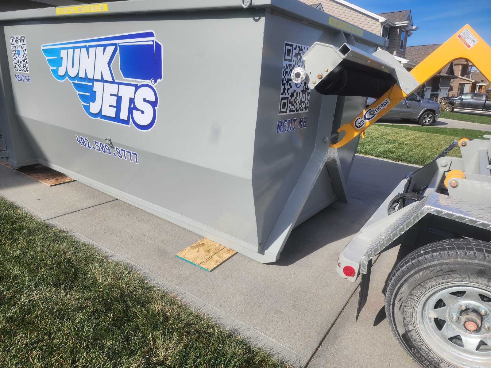 JunkJets roll-off dumpster delivered on a residential driveway
